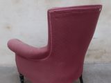 an image of a red chair against a white wall