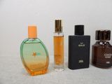 three different bottles of perfume on a white surface