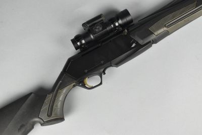 gros plan d'un fusil sur une surface blanche