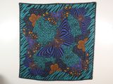 an image of a wall hanging with a blue and orange butterfly design