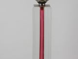 a glass vase with a pink candle inside of it