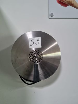 a metal object with a number on it hanging on a wall