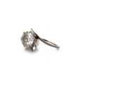 a close up of a single diamond ring on a white background