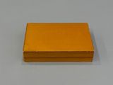 yellow box on a white table with a white background