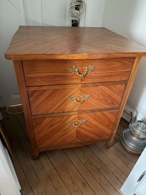 une commode en bois dans le coin d'une pièce
