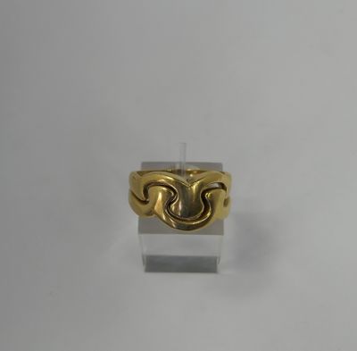 a close up of a gold ring on a white surface