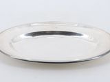 a silver plate on a white table with a white background