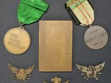 an assortment of medals including a medal, a book, and a book