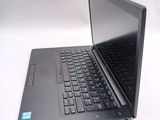 a laptop computer sitting on a white surface with a black keyboard