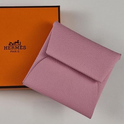 purple leather wallet with orange box and logo on it