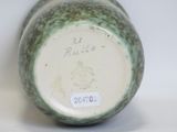 a close up of a vase with a tag on it