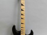 an electric guitar sitting on top of a white surface
