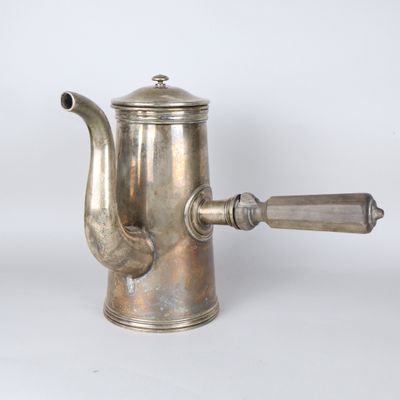 an antique silver coffee pot with a wooden handle on a white background