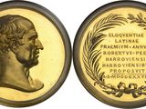 a close up of a gold coin with a portrait of a man