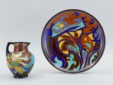 two vases and a plate sitting next to each other