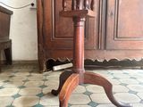 a wooden table with a wooden top on a tiled floor