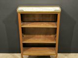 an antique wooden bookcase with two shelves and a marble top