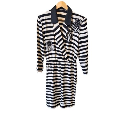 striped dress with black and white stripes on a hanger on a white background