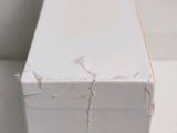 a close up of a piece of wood that has been painted white