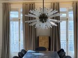 a dining room with a table and chairs and a chandelier