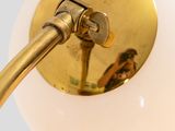 a close up of a light fixture with a white ball on it