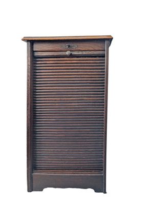 an old wooden shutter door with a drawer underneath it