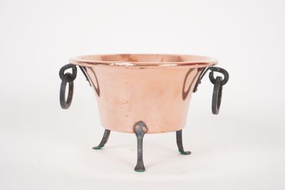 an image of a copper pot with two handles on a stand