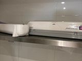 a toilet paper dispenser sitting on a shelf in a bathroom