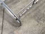 a metal bed frame that is sitting on the sidewalk