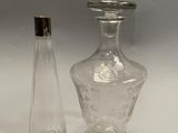 two clear glass vases with silver lids and a silver top