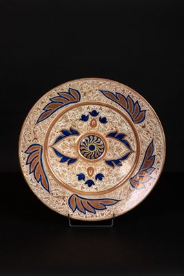 an image of a decorative plate with blue and orange designs