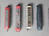 five different types of toy trains lined up on a table