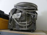 a small air conditioner sitting on a shelf next to a yellow box