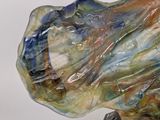 a glass sculpture of a woman ' s head on a stand
