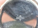 a close up of a person ' s hand holding a silver watch