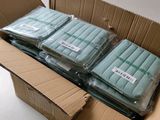 four mattresses in a cardboard box on a table