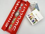 the watch is in a red box with a picture of peanuts on it