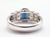 an image of a ring with a blue stone and diamonds