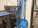a blue broom and a blue shovel next to a table