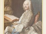 portrait of a man sitting at a desk with a book in his lap
