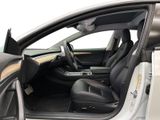the interior of a car with the door open and the driver ' s seat down