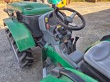 a green tractor that is parked on the side of the road