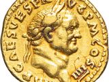 a gold coin with an image of a man wearing a crown on it