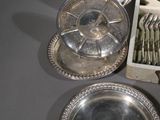 a box of silverware sitting on a table next to a box of silverware