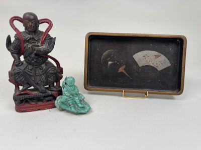 a picture of a statue of a man sitting on a chair next to a box