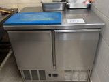 a small kitchen with a blue counter top in the corner of the room