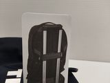 a close up of a black backpack with a white tag on it