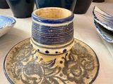 a blue and white vase and a blue and white plate on a table