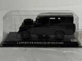 a black vehicle in a clear box on a white surface