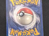 the pokemon card is sitting on top of a black table